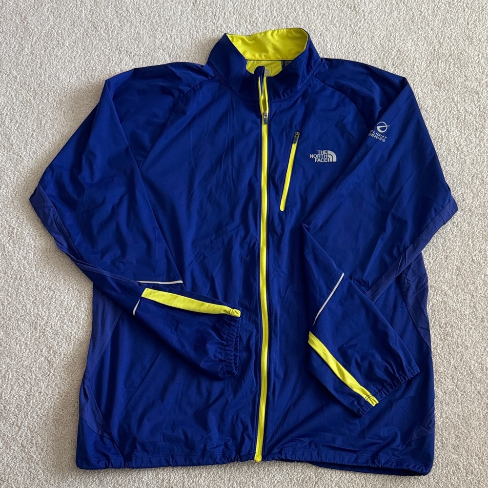 The North Face Men's Blue Windbreaker with Yellow Accents